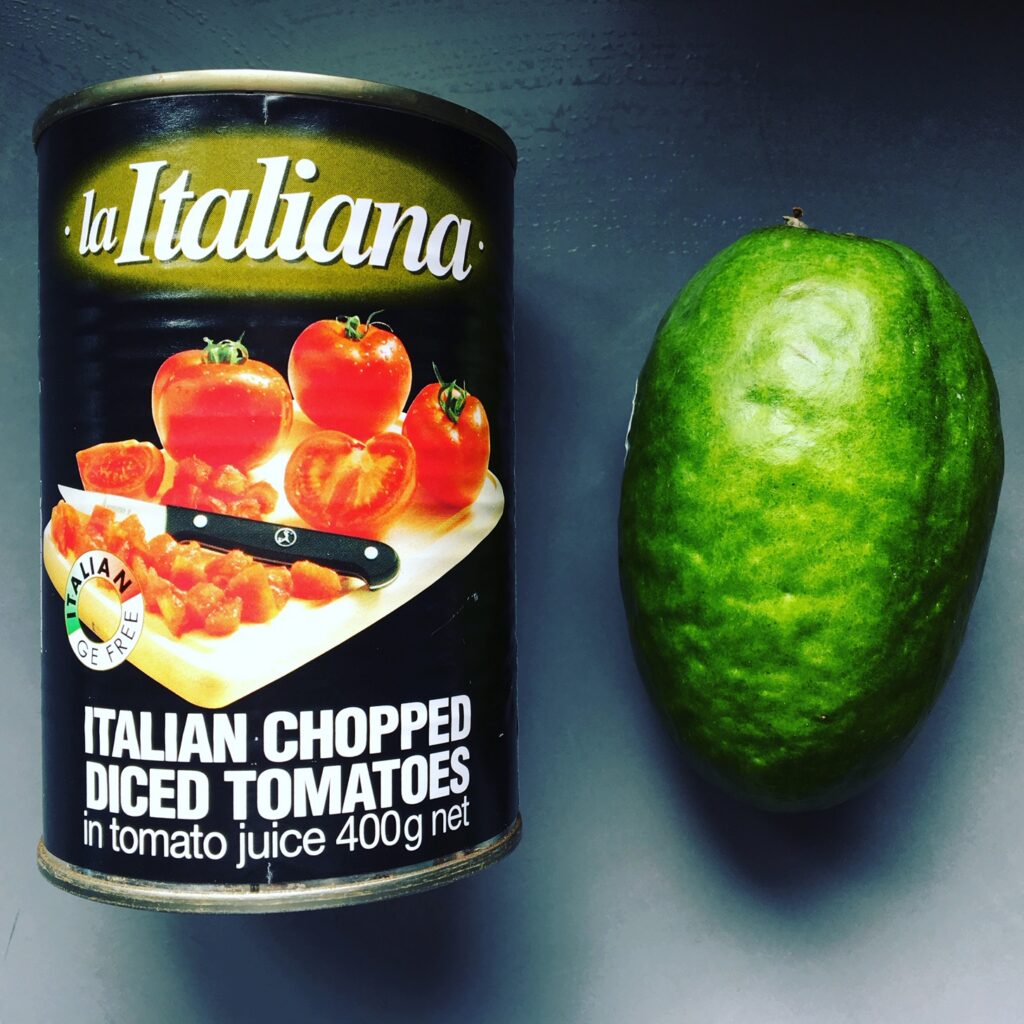 Green feijoa fruits gathered in a bowl on a kitchen table